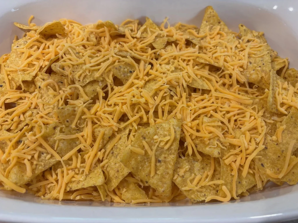 chili queso nachos with avocado & cilantro before bake