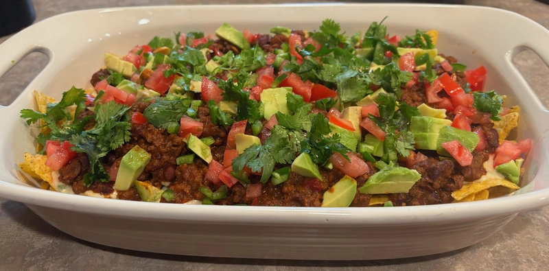 chili queso nachos with avocado & cilantro closer look