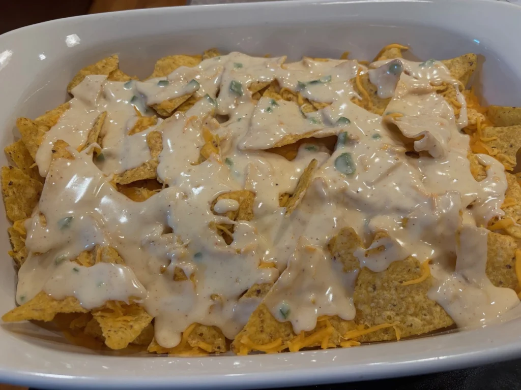 chili queso nachos with avocado & cilantro top queso