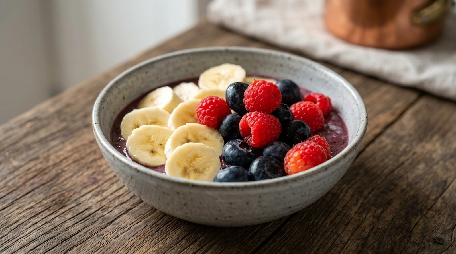 Berry Yogurt Smoothie Bowl with Acai Berry yogurt smoothie bowl with acai topped with banana slices, raspberries, and blueberries
